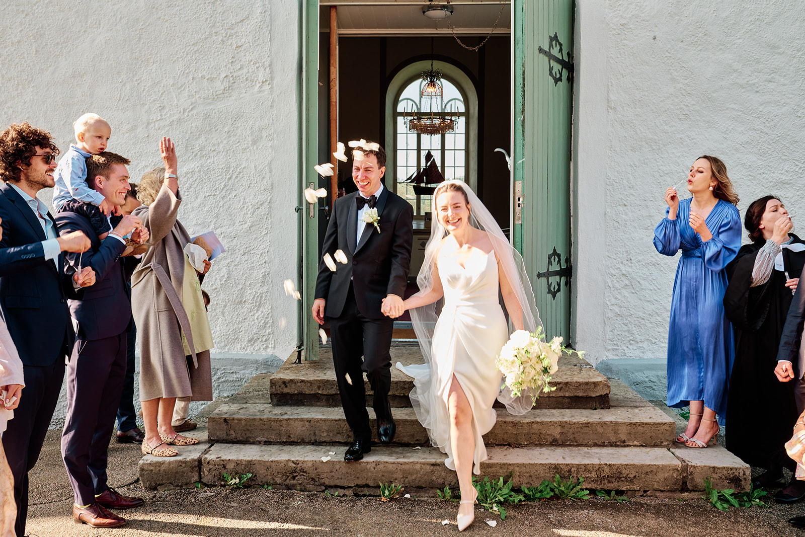 The couple coming out of the church door to applause