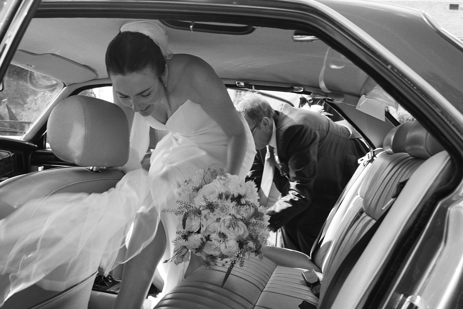 Bride and groom in the wedding car, black and white