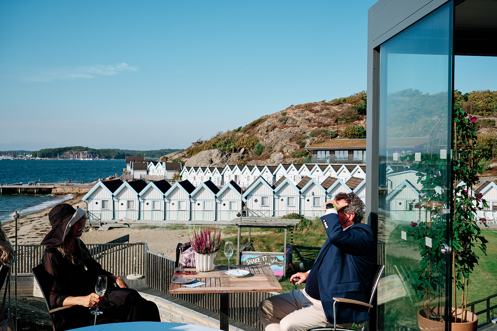 The glass dining room at Hov&aring;s Kallbadhus above the cabins and the sea