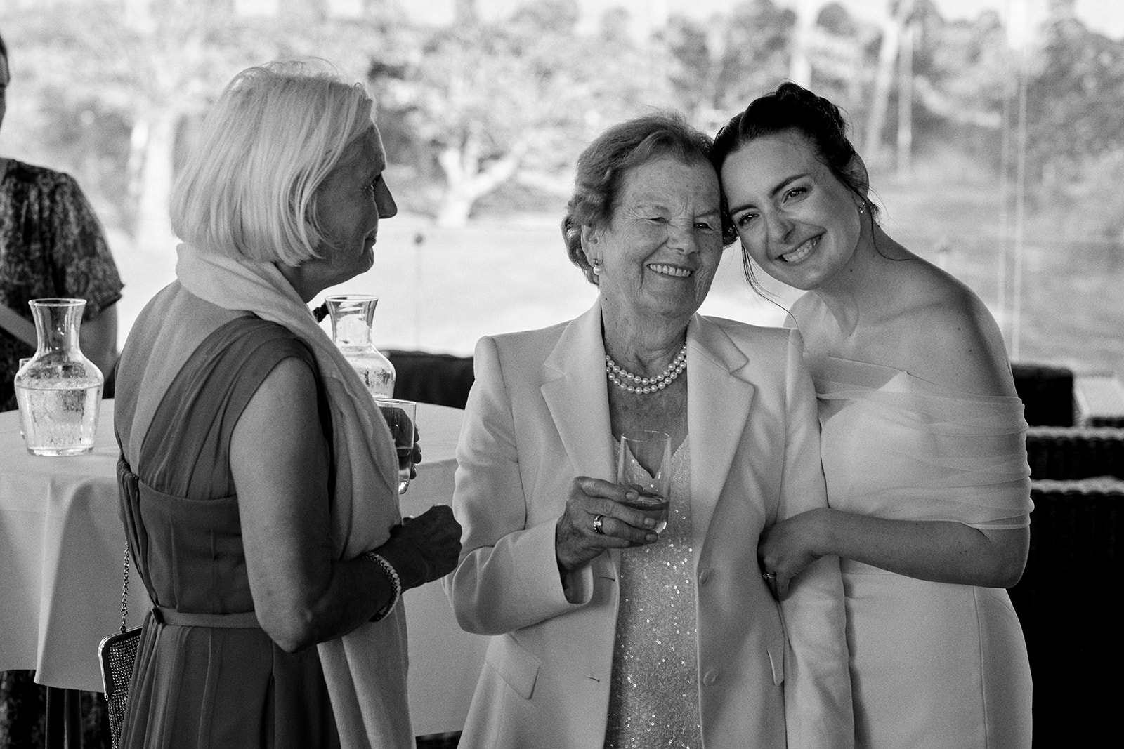 Three guests laughing together, black and white