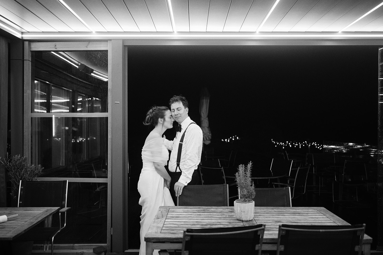 The couple dancing alone in the dining room over the water